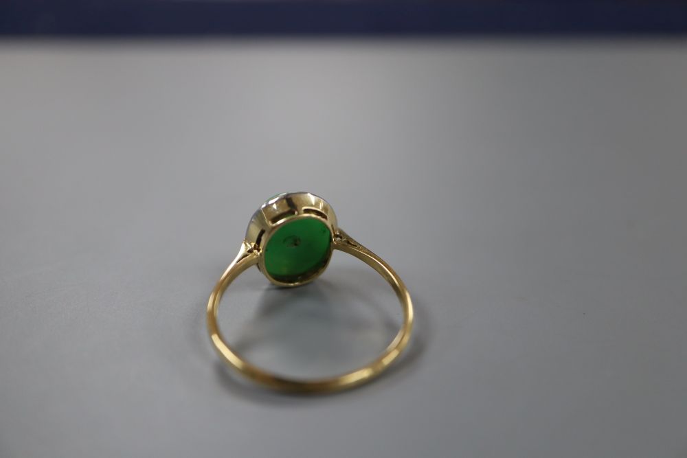 An 18ct and oval cabochon jade set ring, size Q, gross 2.8 grams.